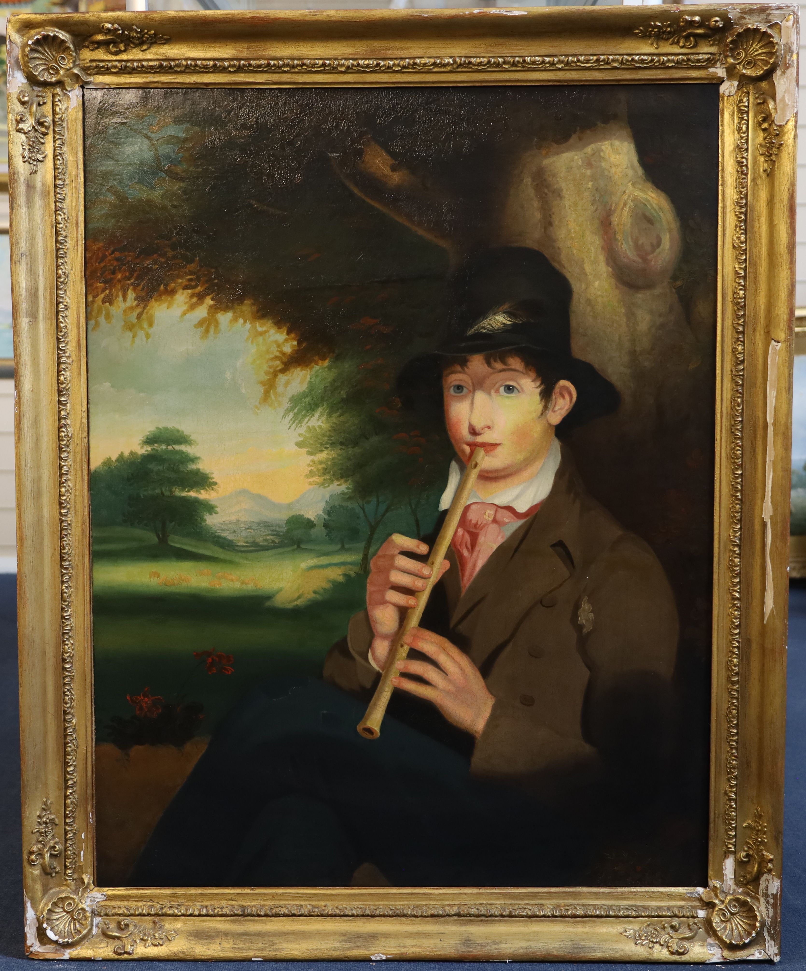 English School c.1840 Naive portrait of a pipe player seated in a pastoral landscape 35. x 28in.